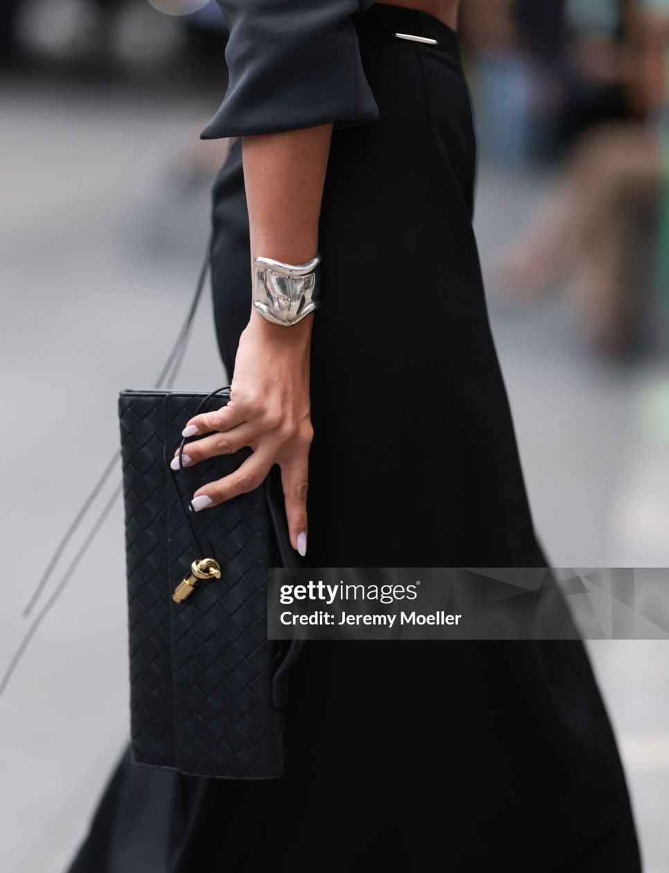 Tamara Kalinic seen wearing black long maxi skirt, Tiffany & Co silver Elsa Peretti Small Bone Cuff and Bottega Veneta black woven leather Andiamo clutch bag, during the New York Fashion Week, on September 06, 2024 in New York City. (Photo by Jeremy Moeller/Getty Images)