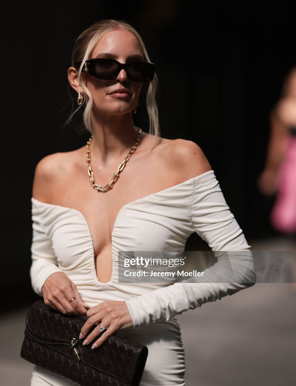 Leonie Hanne seen wearing white white off the shoulder long sleeve Carolina Herrera midi dress, Bottega Veneta Andiamo black clutch, black heels, Tiffany & Co City Hardware Collection yellow gold diamond necklace and earrings, black sunglasses outside Carolina Herrera Show during New Yorker Fashion Week on September 09, 2024 in New York City. (Photo by Jeremy Moeller/Getty Images)