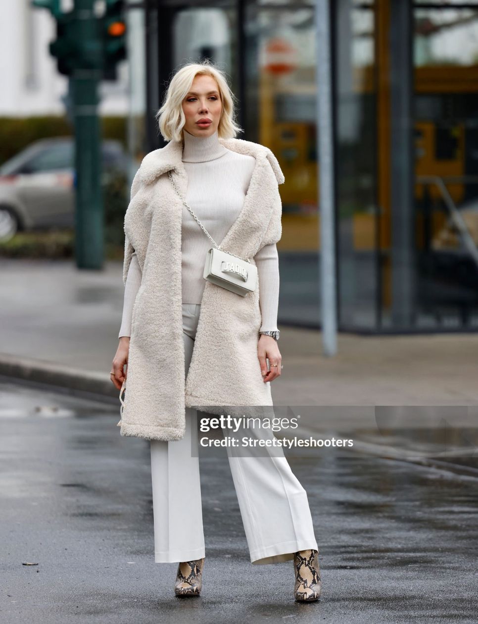 Hair stylist Svenja Simmons wearing a cream colored long teddy vest by Marsh, a cream colored turtleneck pullover by Rene Lezard, cream colored pants by Escada, a cream colored bag with silver details by Dior, beige and brown snake print booties by Paris Texas and sunglasses by Tom Ford during a street style shooting on March 16, 2021 in Duesseldorf, Germany. (Photo by Streetstyleshooters/Getty Images)