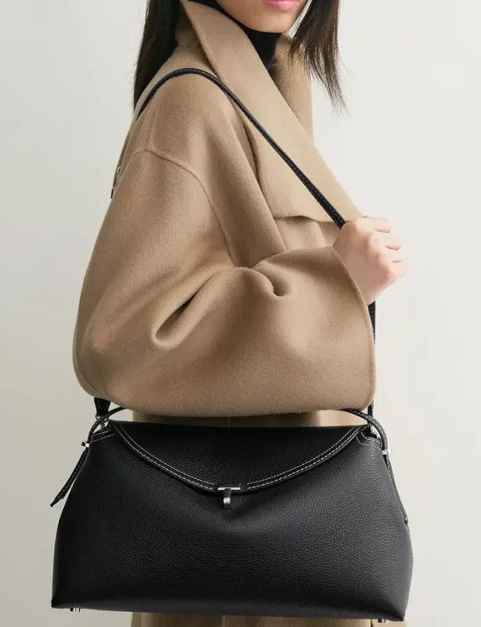 9. Toteme T-Lock Grained Leather Top Handle Bag Black