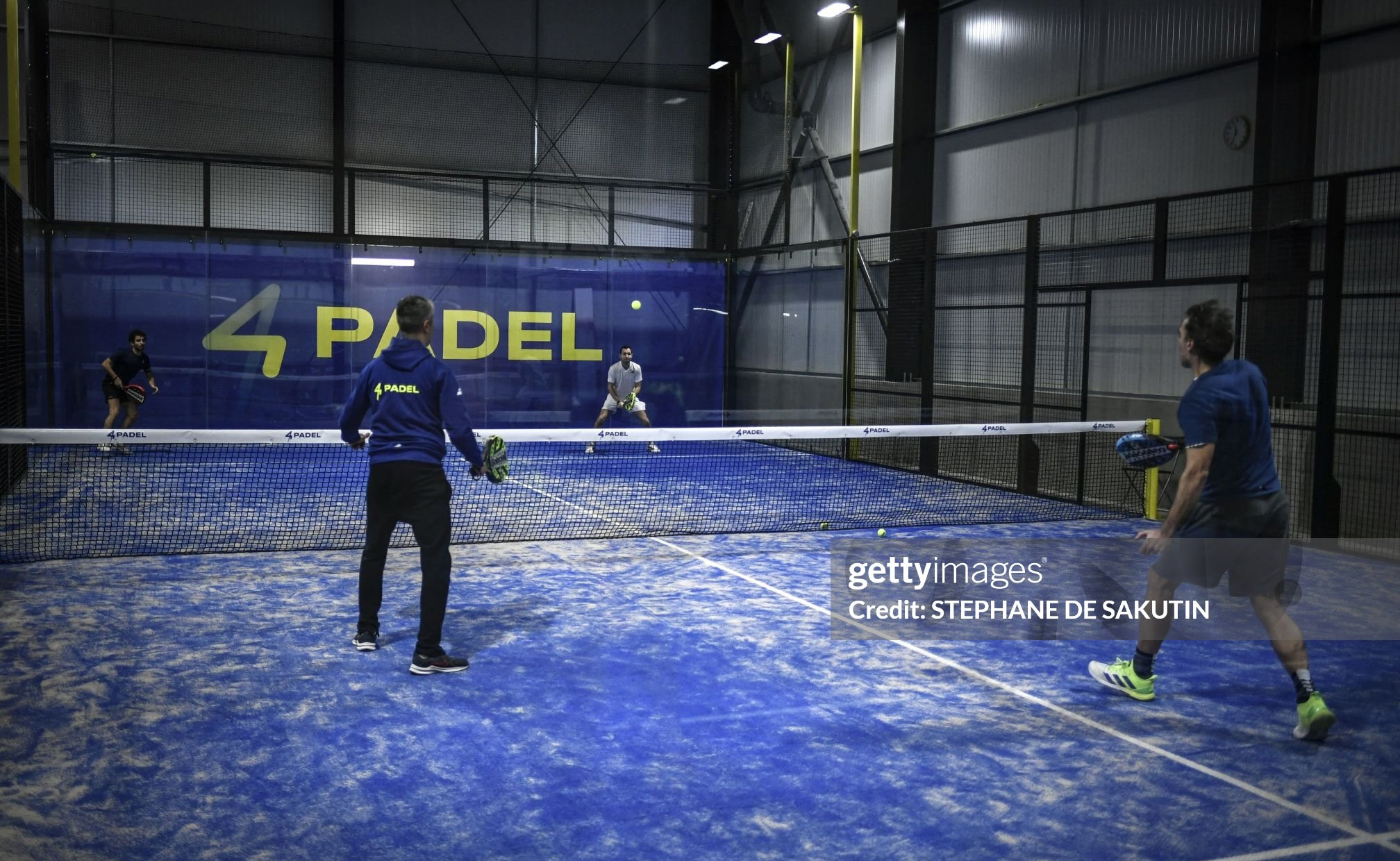 People play on a padel tennis court on February 2, 2023, in Montreuil, northern suburb of Paris. (Photo by STEPHANE DE SAKUTIN / AFP) (Photo by STEPHANE DE SAKUTIN/AFP via Getty Images)