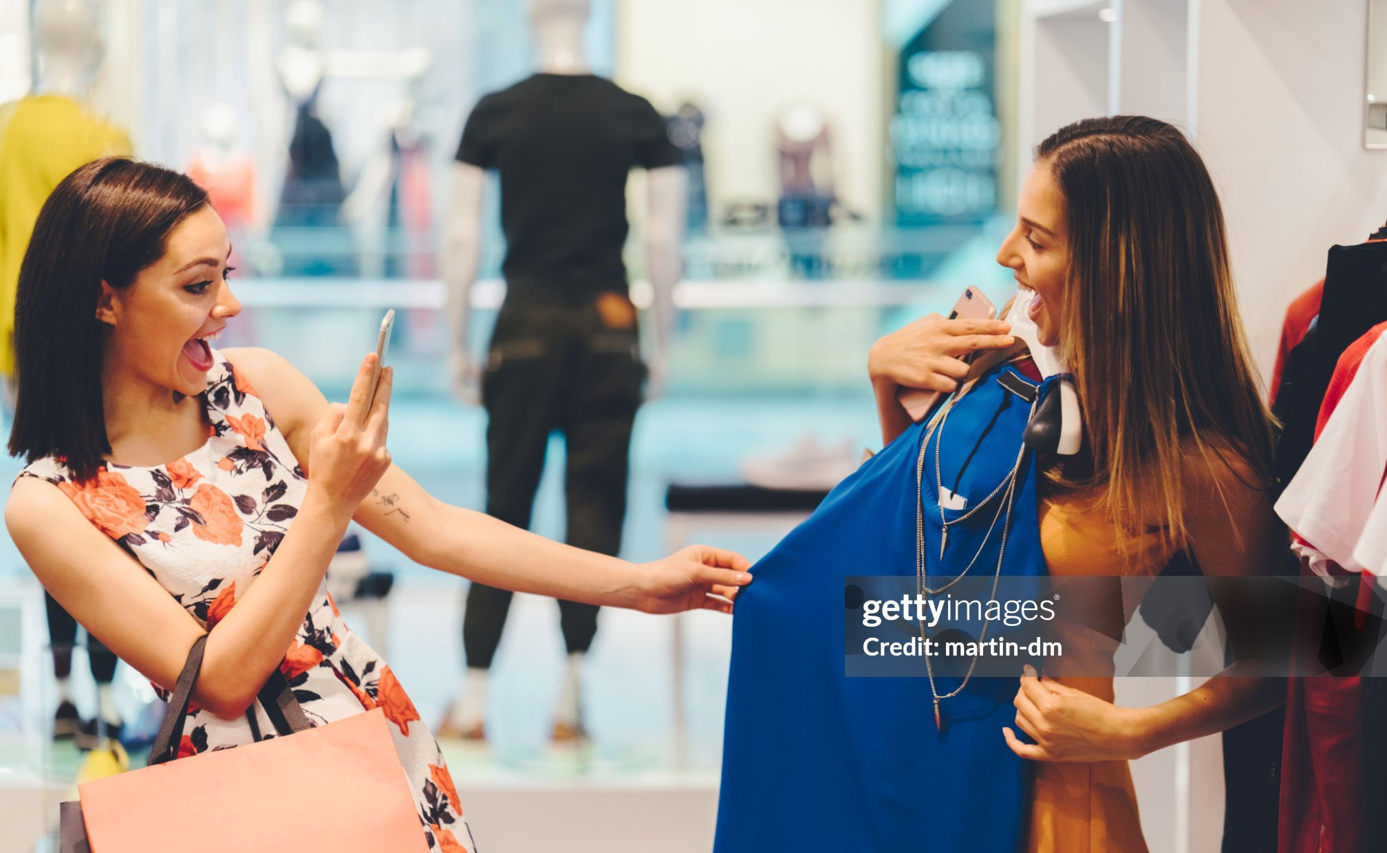 Girls enjoying a fashionable dress in the shop Getty Image